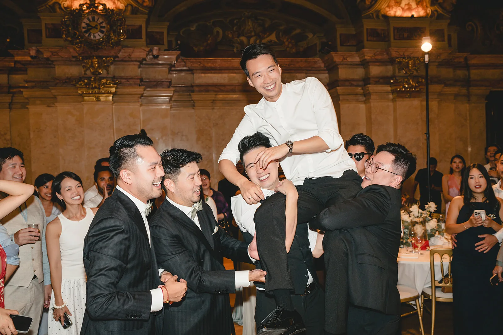 Anthony lifted onto the shoulders of his groomsmen