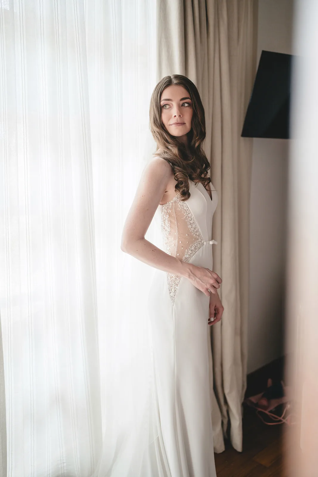 Jennise in her wedding dress by the window, shortly before the ceremony