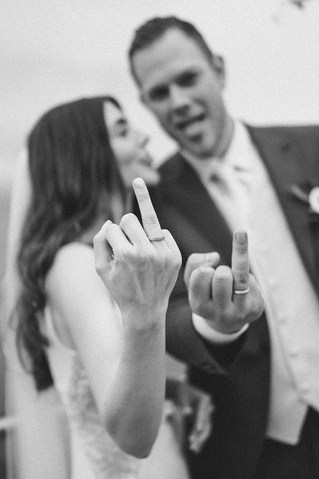 Jennise and Florian laughing as they show the rings on their fingers