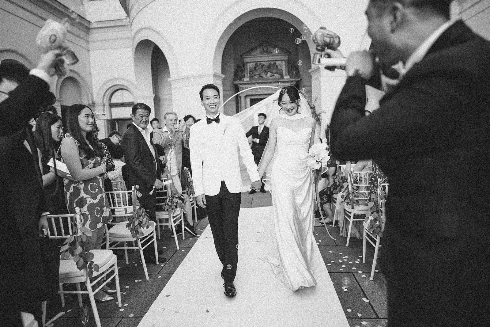 Recessional through the flower-lined aisle after the ceremony