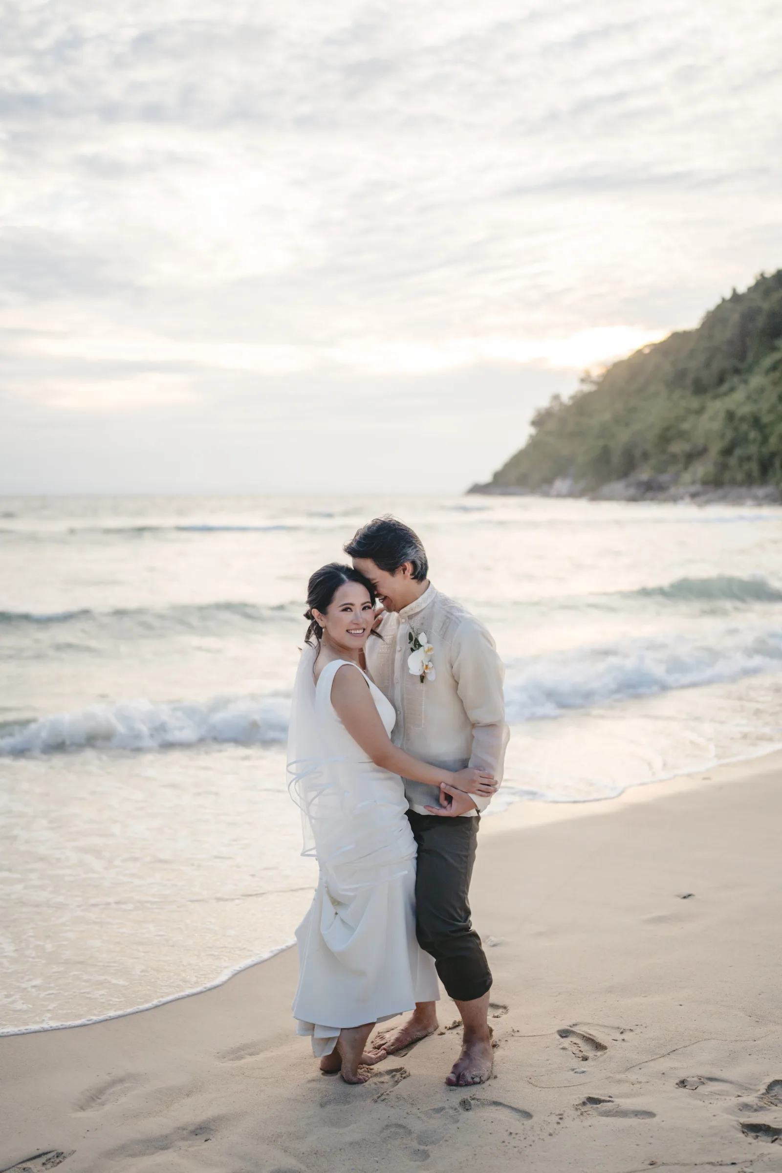 Bride and groom on the beach in the evening sun — destination wedding in Phuket, Thailand